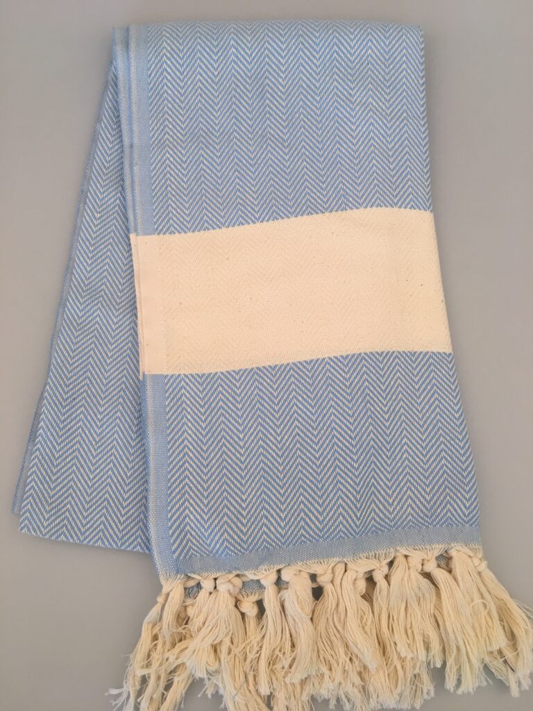 Light blue herringbone peshtemal with a cream stripe and knotted fringes